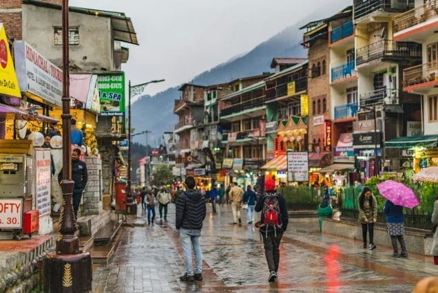 Bustling mountain town street scene on manali to kasol distance route