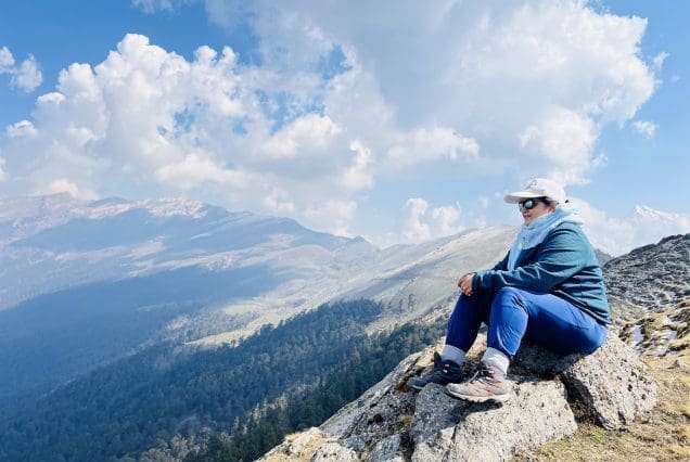 Solo hiker gazes at forested peaks on the Gulmarg distance from Srinagar trail