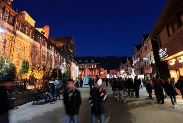 Festive street scene at night in Mashobra India with lit-up buildings and evening crowd
