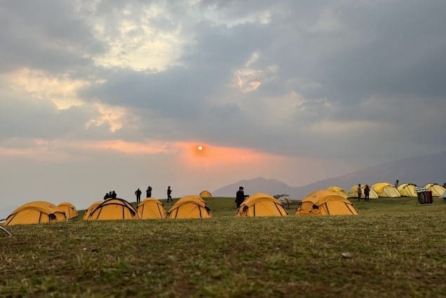 Sunset over yellow tents in the highlands on the Srinagar to Pahalgam trail