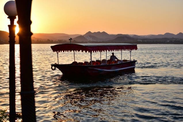 Sunset boat ride with hills in view — udaipur to jaisalmer journey