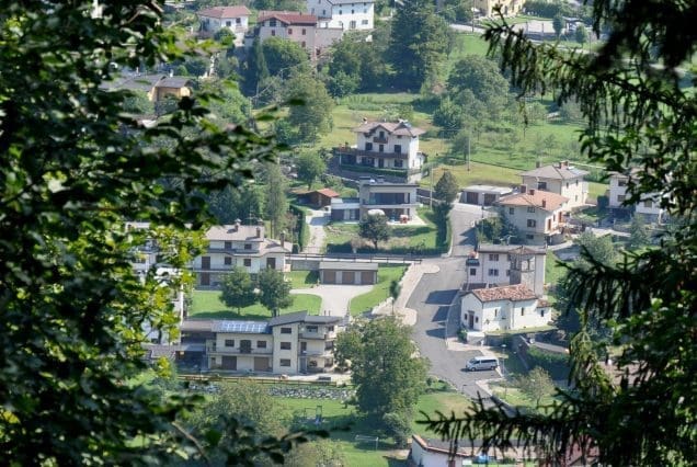 Serene village framed by trees on the Pahalgam to Srinagar journey