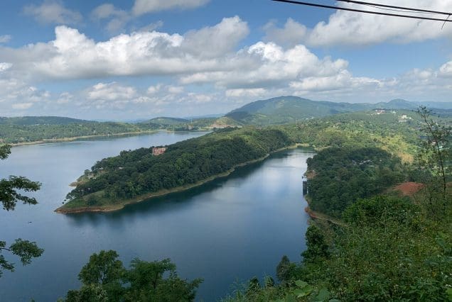 Winding lake surrounded by lush hills near Mawsynram village