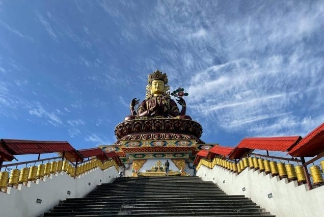 Grand staircase leading to ornate statue at temple site — Sikkim to Bengal journey