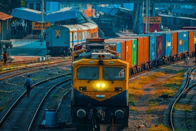 Colorful freight train at a busy railway yard with Jodhpur to Jaisalmer distance keyword