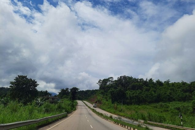Curving road through lush greenery near Kaziranga National Park
